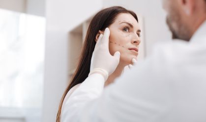Diligent bright plastic surgeon in the middle of the process