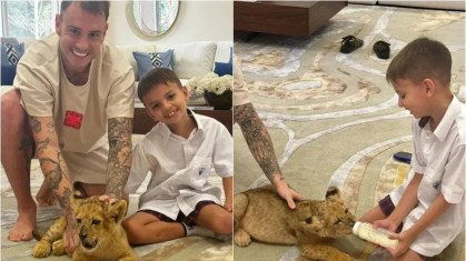 Roger Guedes ao lado do filho, com seu leão de estimação