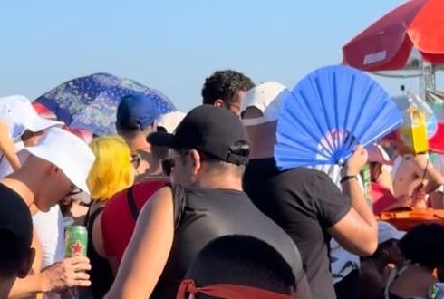 Fã usa leque para se proteger do sol enquanto espera por Madonna / Giovanna Bronze/CNN Brasil