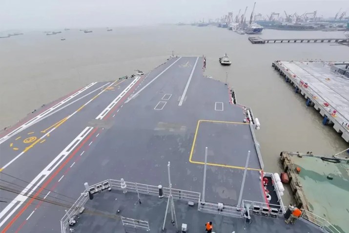 Um rebocador reboca o terceiro porta-aviões da China, o Fujian, para longe de uma doca em Xangai, no leste da China, em 1º de maio de 2024 / Li Tang/Xinhua