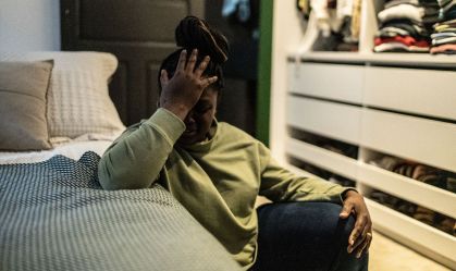 Worried mid adult woman in the bedroom at home