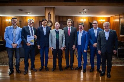 Alexandre Padilha (segurando documento) participou de evento com Fernando Haddad (com gravata vermelha) no Ministério da Fazenda