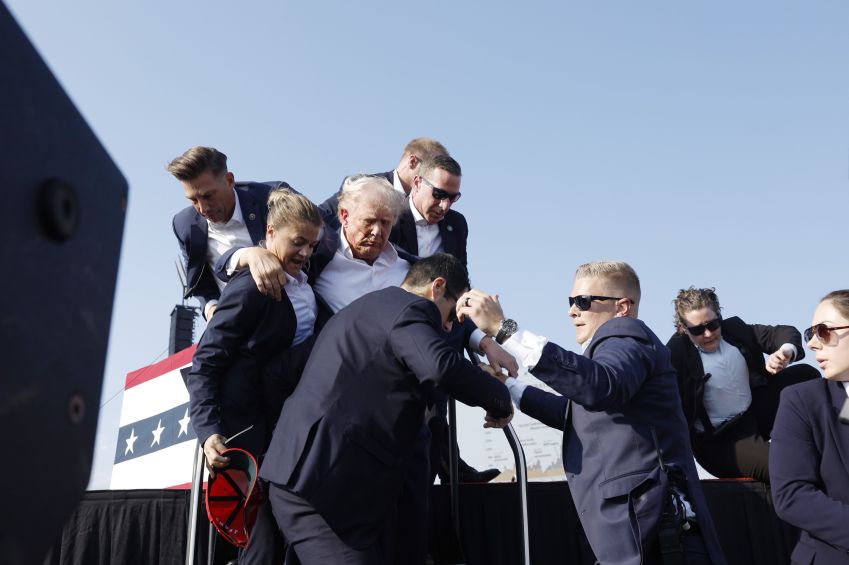 Donald Trump is taken out of stage a wound on his face and was bleeding. • Anna Moneymaker/Getty Images