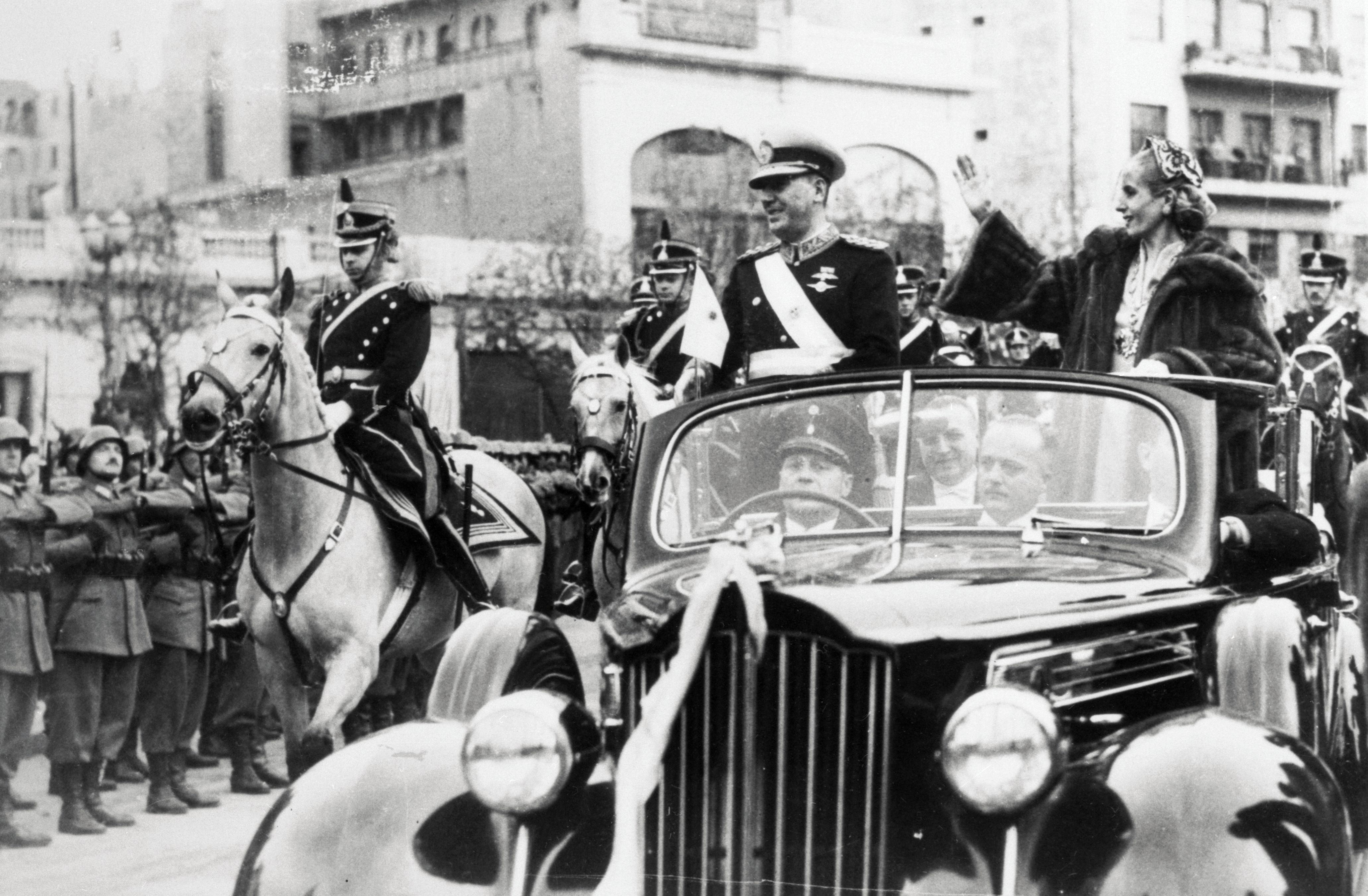 O presidente Juan Perón e a primeira-dama Eva Perón andam em um carro aberto pela Avenida de Mayo em Buenos Aires após a posse de Perón para um segundo mandato. Esta seria a última aparição pública de Eva Perón antes de sua morte um mês depois. / Bettmann / Getty Images