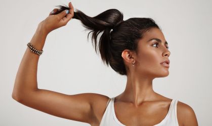spanish woman holding and pull a ponytail