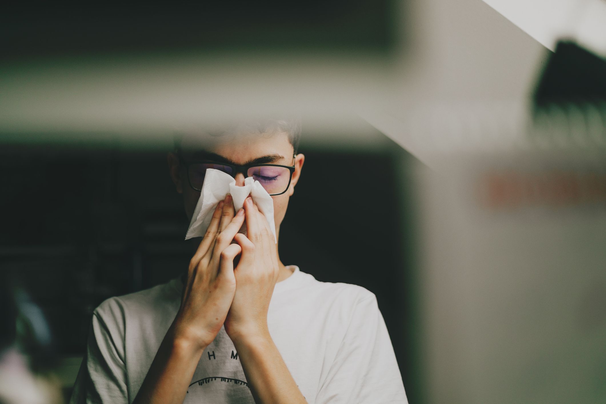 Boy Wiping Runny Nose With a Tissue