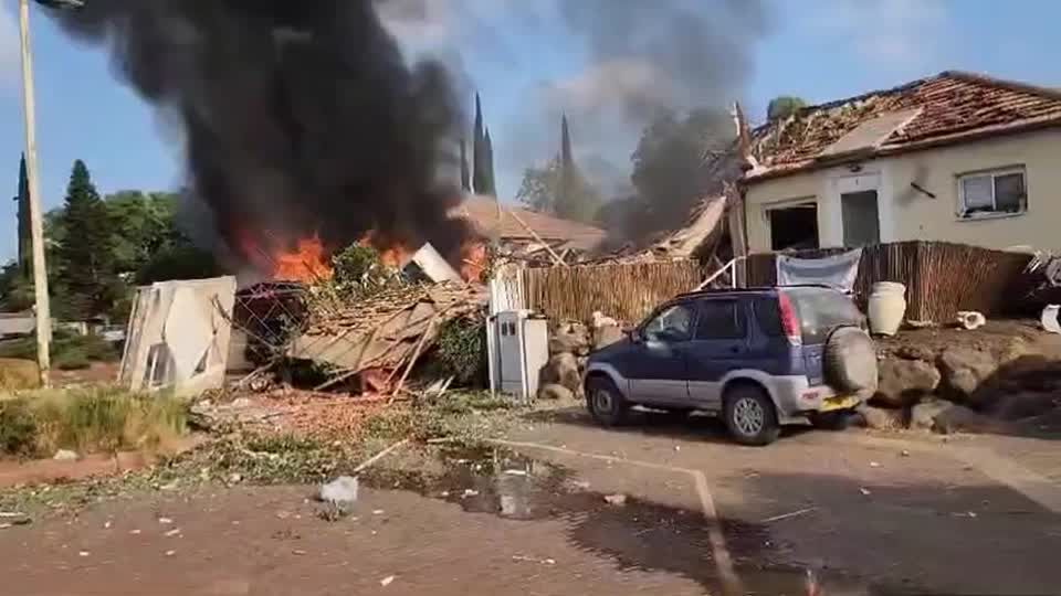 Ambulances, smoke at site where a rocket from Lebanon hit Israeli homes