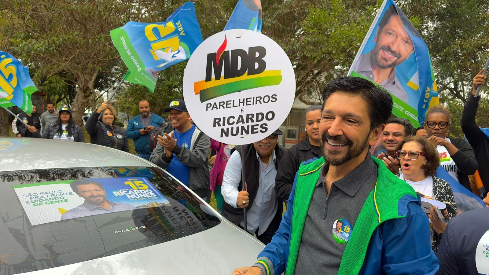 O candidato à reeleição, Ricardo Nunes (MDB), durante "adesivaço" • Reprodução