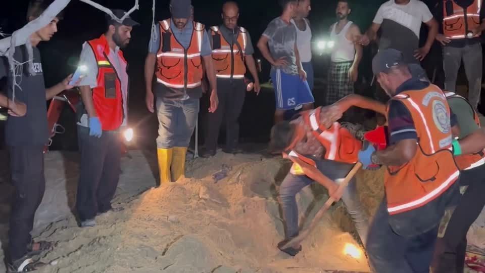 Rescuers work on site of Israeli strikes on Gaza tent camp