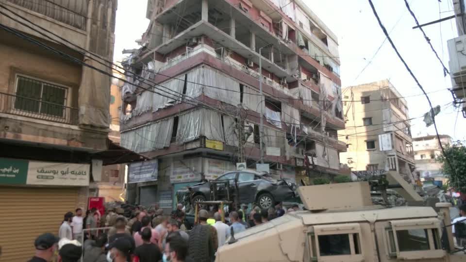 Lebanese civil defense remove rubble of building destroyed by Israeli air strike