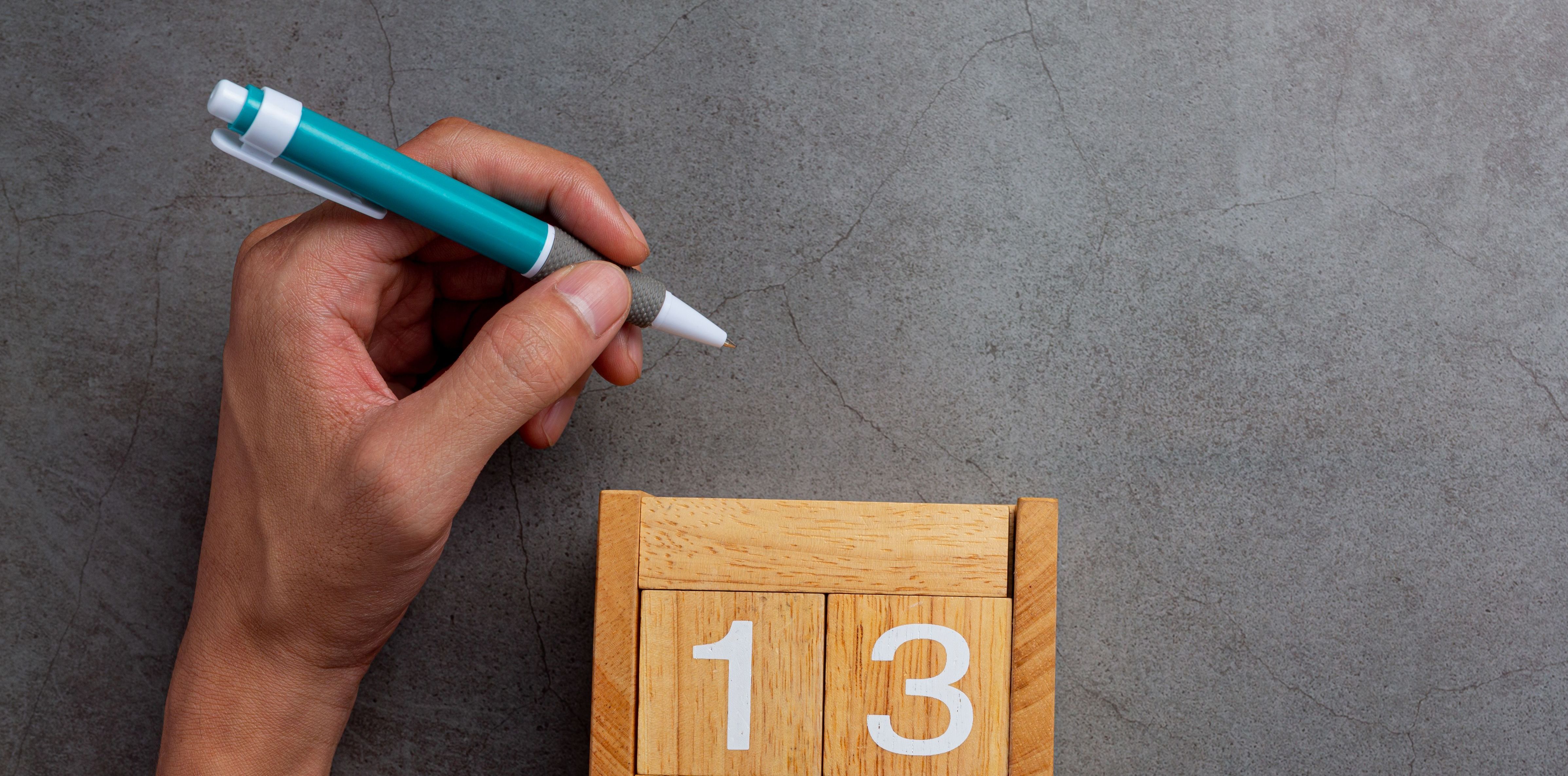 a man left-hand with a pen.Left hander day concept.