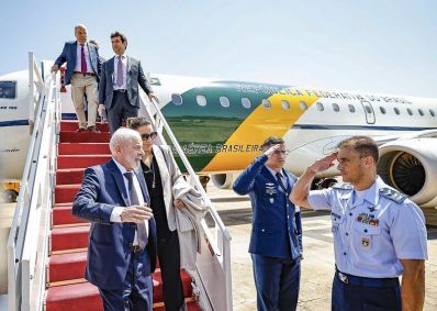 O presidente Lula (à esquerda) e sua comitiva chegam ao Brasil após problema em avião presidencial