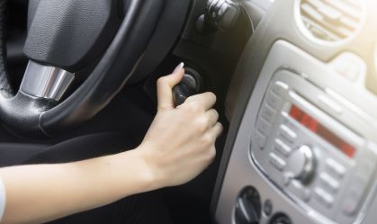 Close-up of female hand adjusting a rear-view mirror
