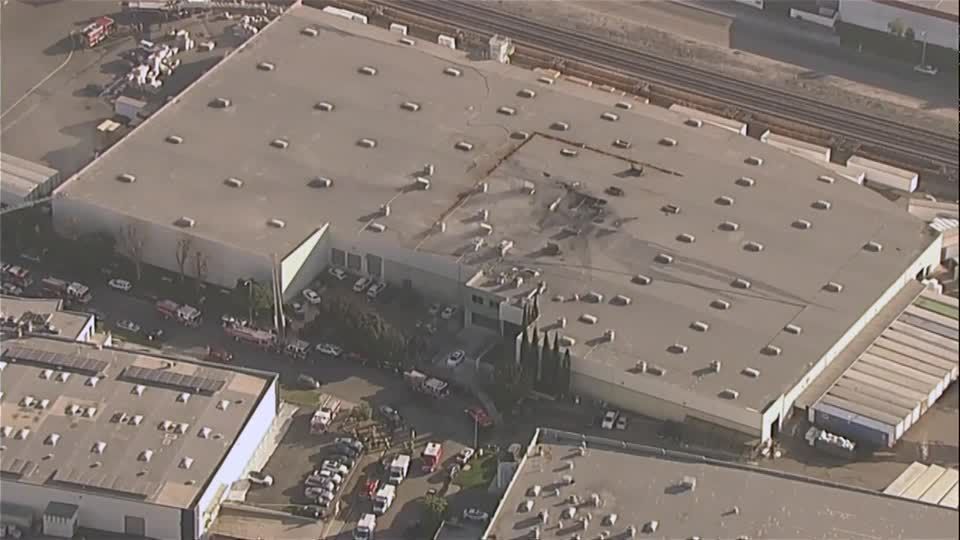 One dead and at least 15 injured after plane crashes into warehouse in California