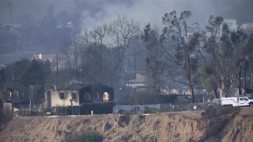 Smoke rises on the LA coast as wildfires continue to smolder