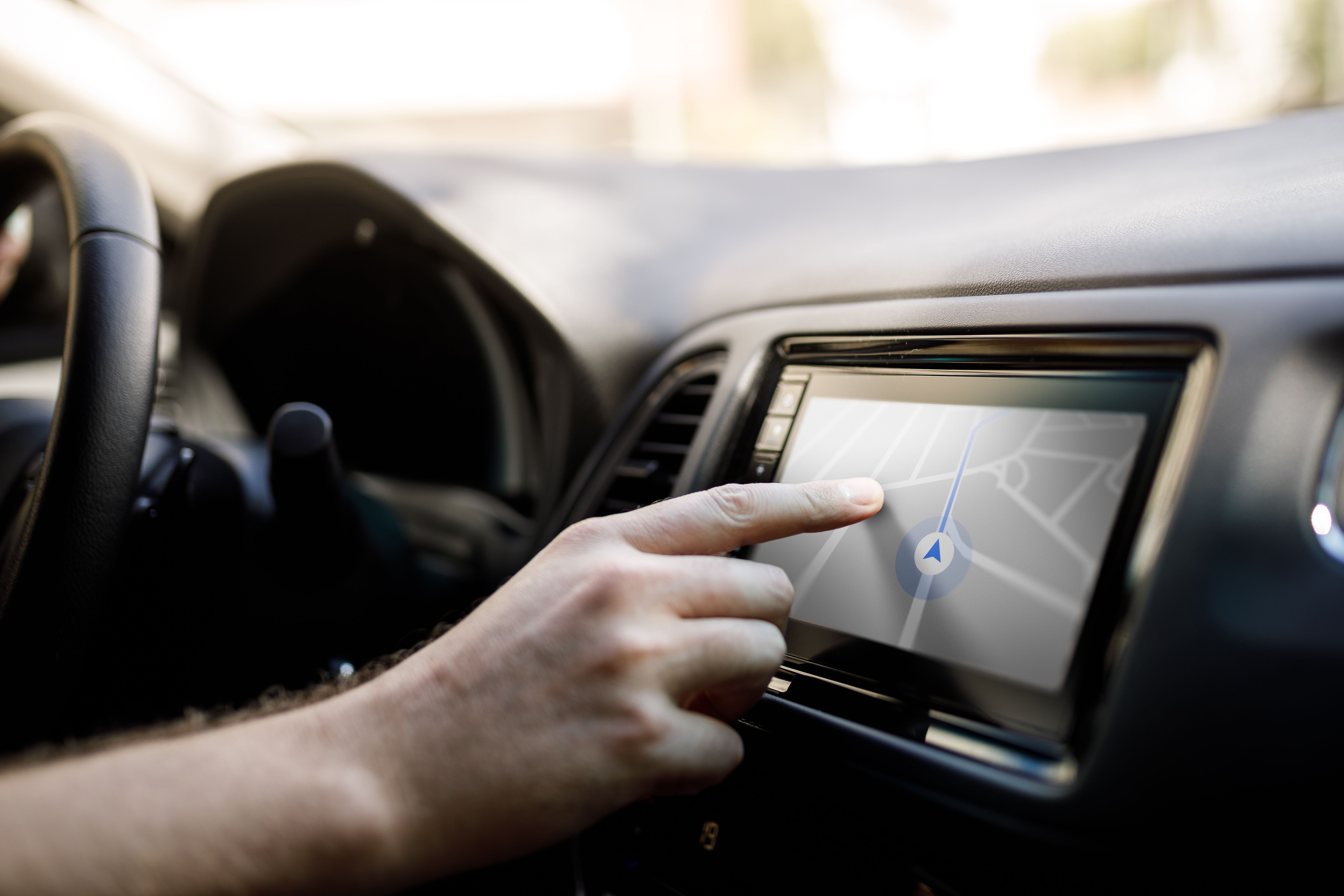 Person checking directions at the car media player