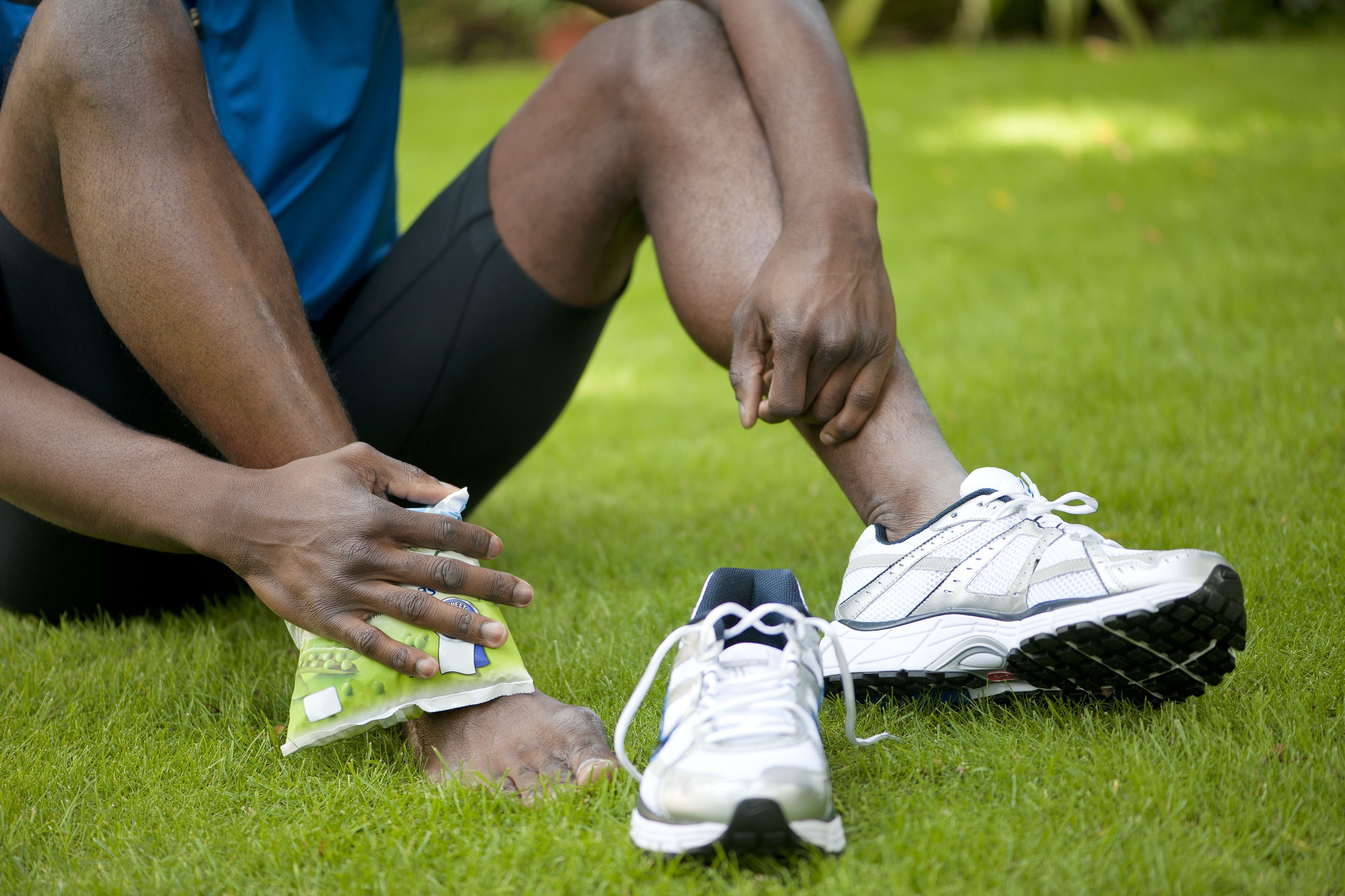 Applying ice pack to injured ankle