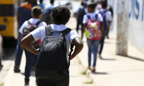 estudante com mochila nas costas caminhando