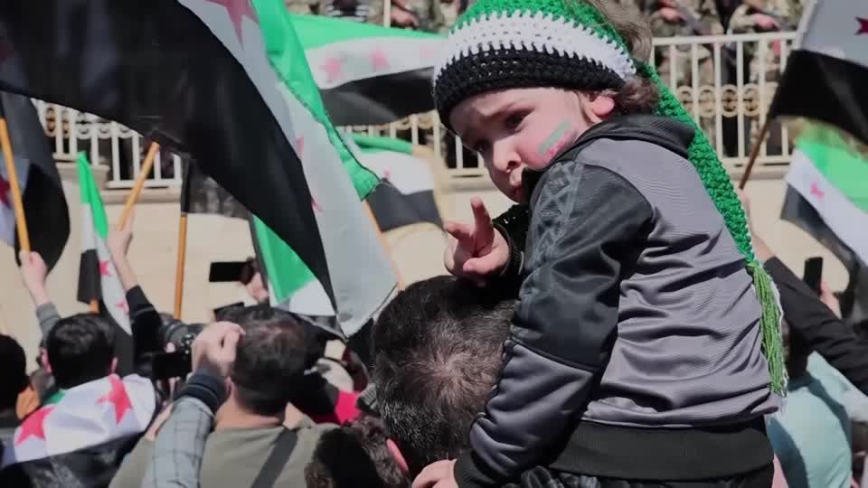 Syrians rally in Idlib to mark the 14th anniversary of the uprising