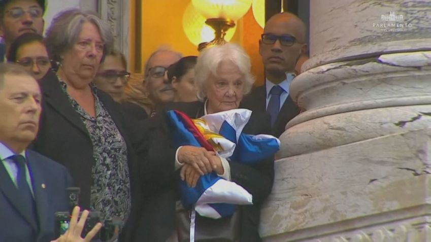Lucía Topolansky, viúva de Pepe Mujica, segura as bandeiras que estavam em cima do caixão do ex-presidente • TV Governo Uruguai