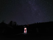 Jiayi Wang fotografou um colega da Universidade de Geociências da China entrando em uma cabana no leste da Sibéria contra o fundo escuro de um céu estrelado