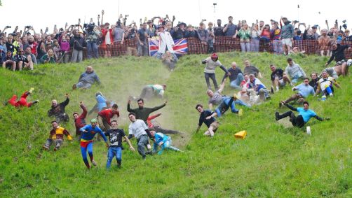 Participantes da Corrida de Queijos Rolantes em Cooper's Hill, na Inglaterra