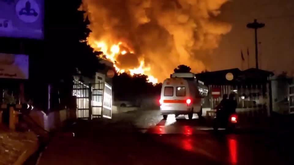 Rescuers move through damaged building as fires rage after Israeli strikes reported in Tehran