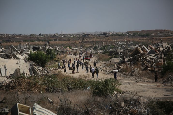 Palestinos, incluindo crianças, caminham rumo ao norte da Faixa de Gaza, em Deir Al-Balah, após início do cessar-fogo. • Hassan Jedi/Anadolu via Getty Images