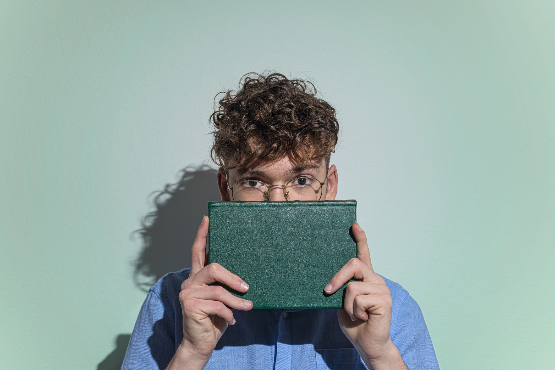 Man Covering Face With Book