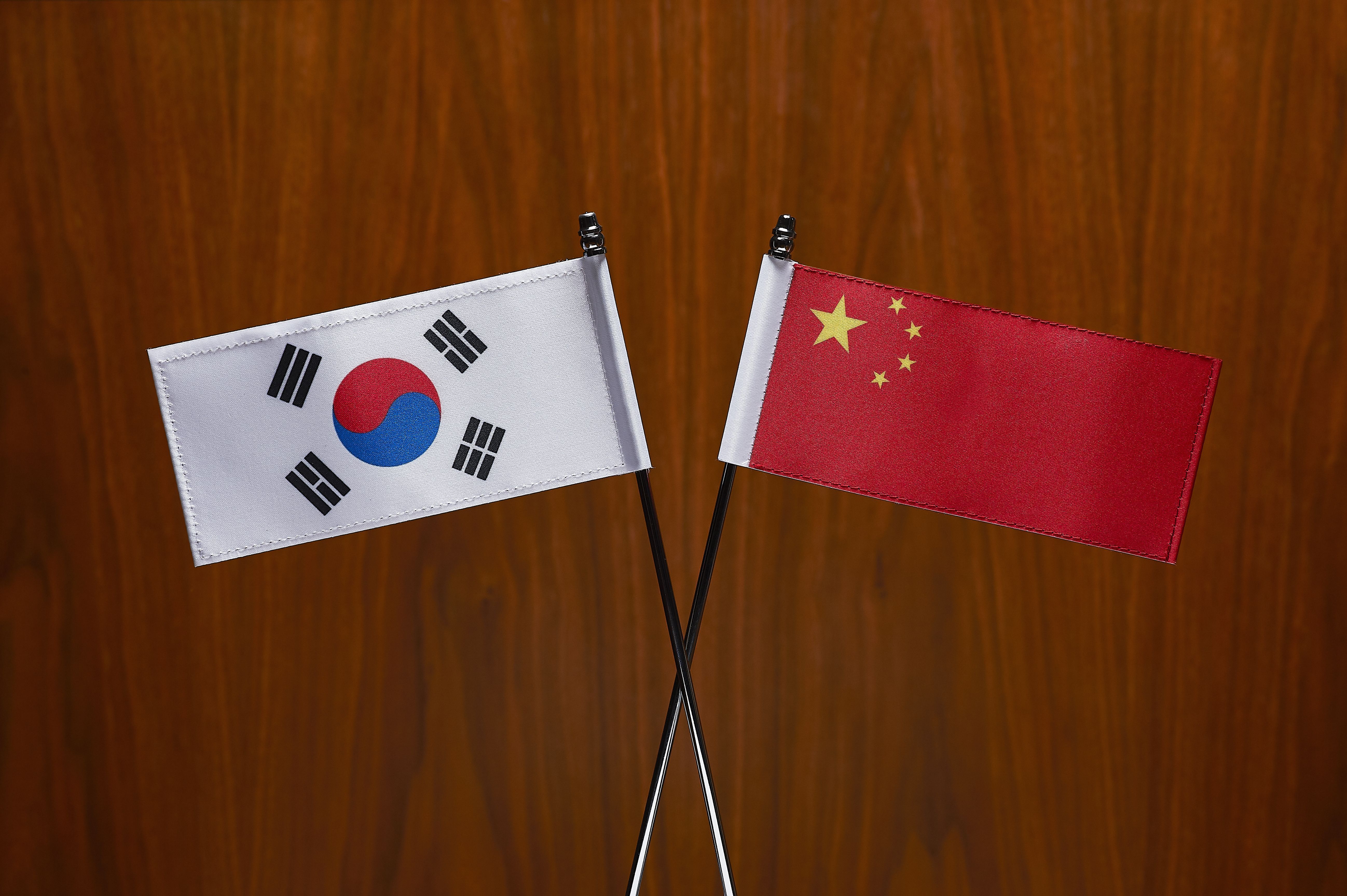 South Korean and Chinese Flags. Close-up.