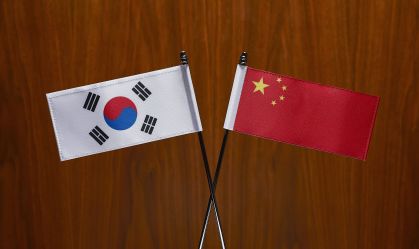South Korean and Chinese Flags. Close-up.