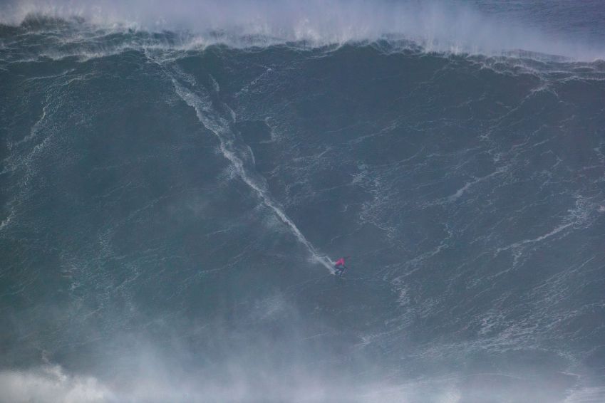 Uma das ondas gigantes surfadas pelo brasileiro Lucas Chumbo em Nazaré, Portugal, para ser campeão mais uma vez • Damien Poullenot/World Surf League via Getty Images