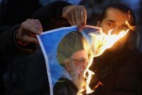 Manifestantes queimam fotos do aiatolá Ali Khamenei em apoio a protestos