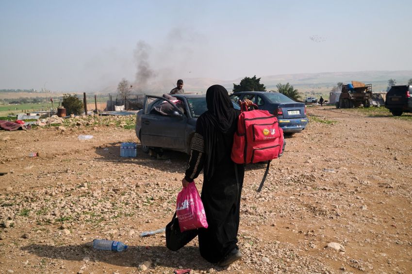 A Palestinian Bedouin woman collects her belongings from a village that has been her home for 45 years, after being forced to move • Jeremy Diamond/CNN via CNN Newsource