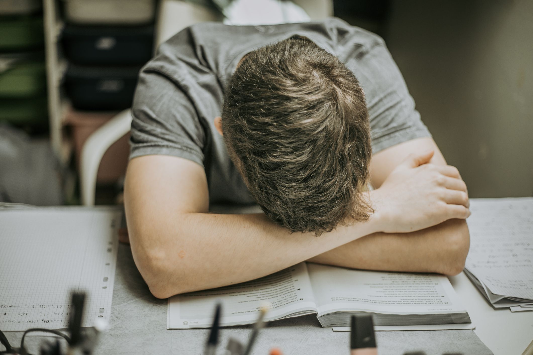 exhausted tired student resting on books