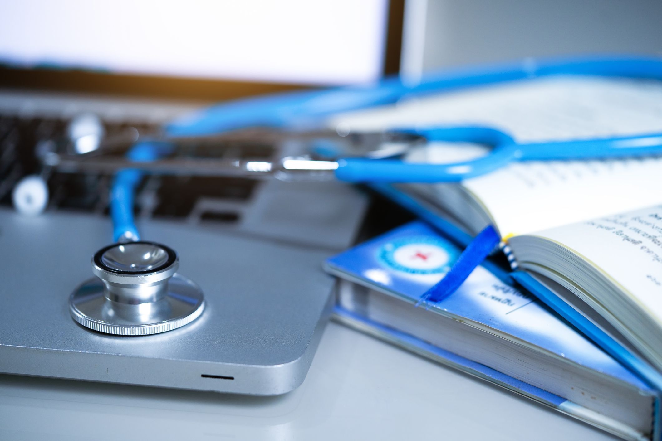 Medical stethoscope with books and laptop