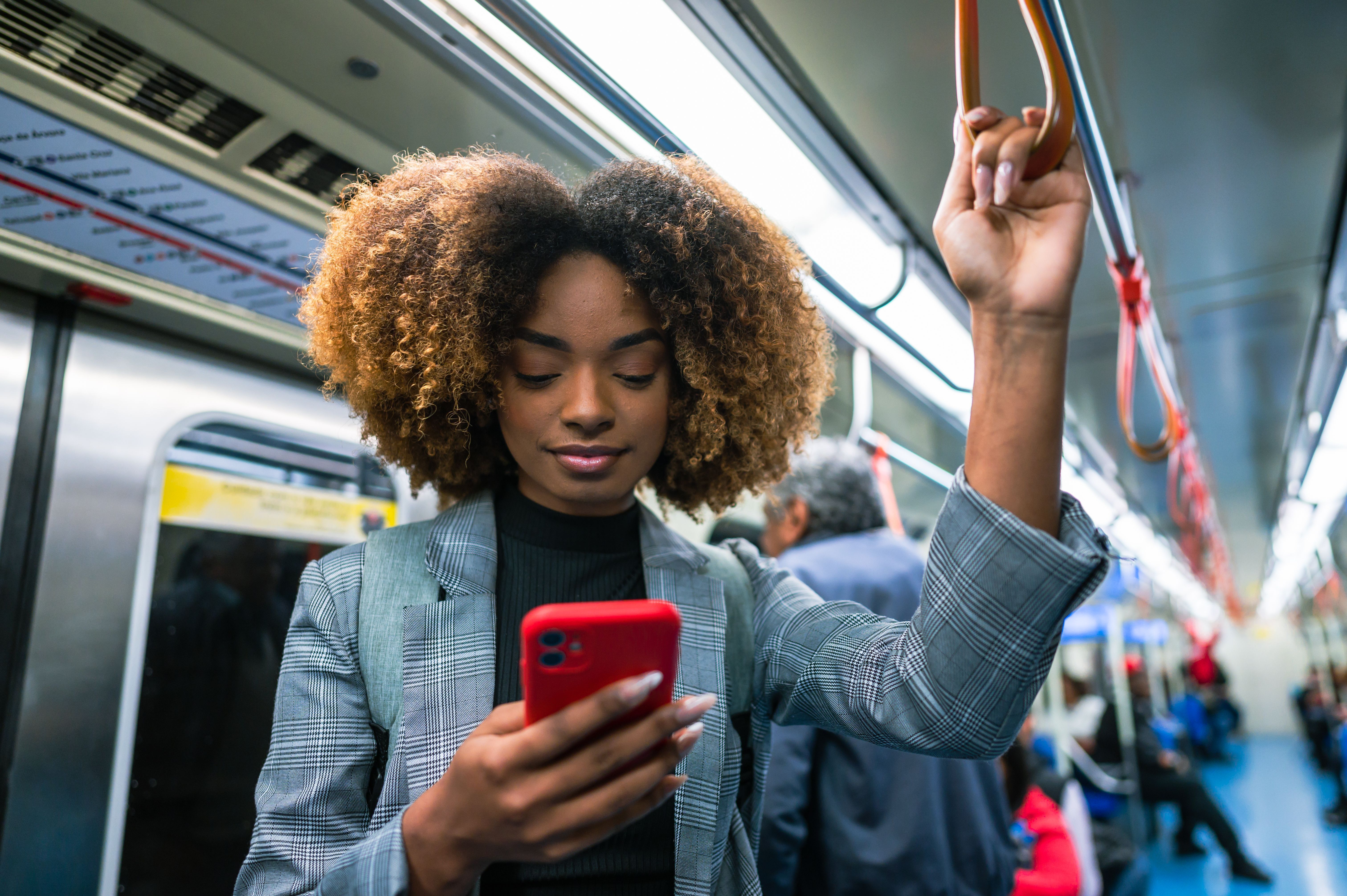 A  woman using her cell phone on the bus