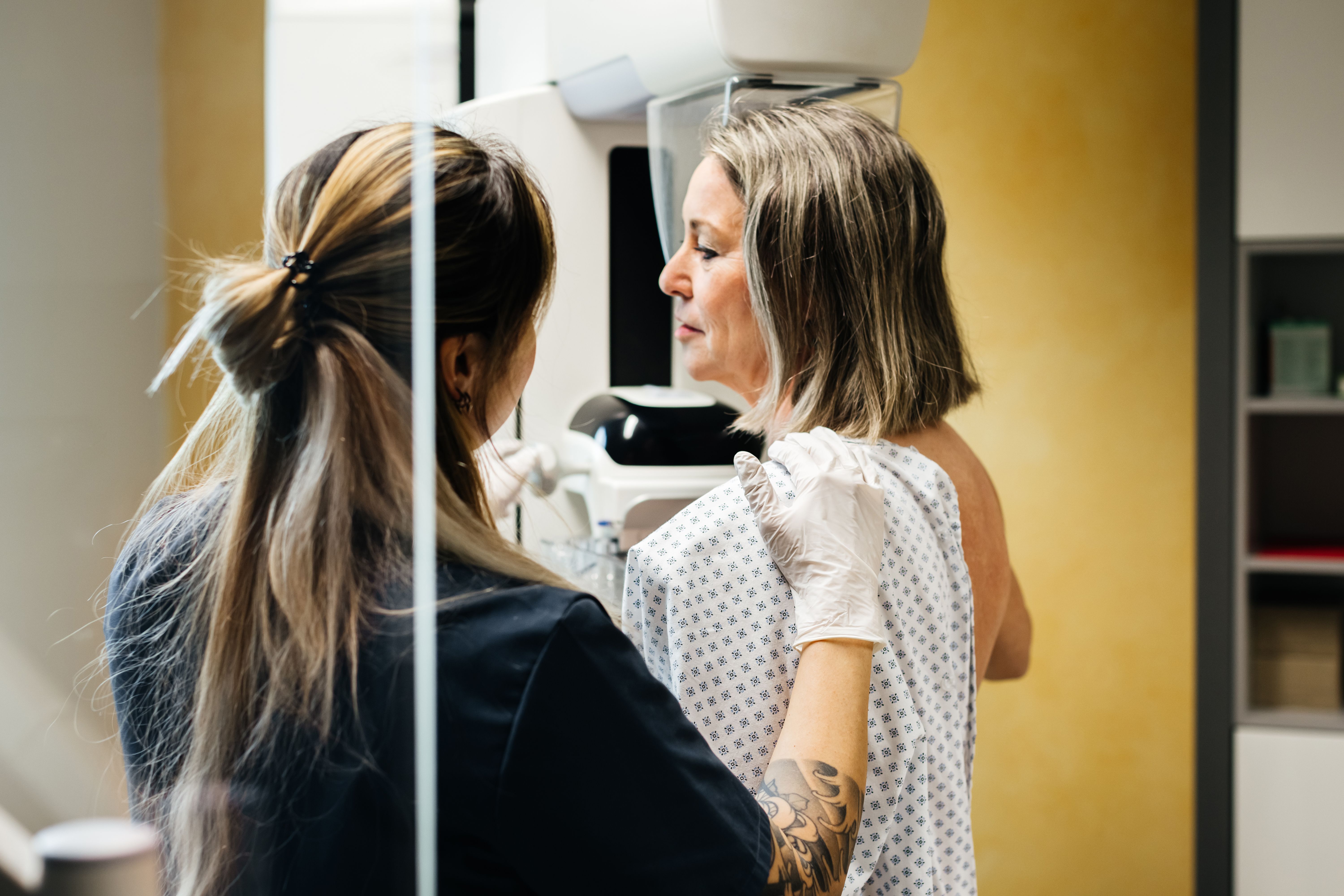 Nurse Assisting Patient During Mammogram
