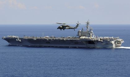 Atlantic Ocean, October 10, 2010 - An MH-60S Seahawk helicopter flies over the aircraft carrier USS George H.W. Bush (CVN-77).