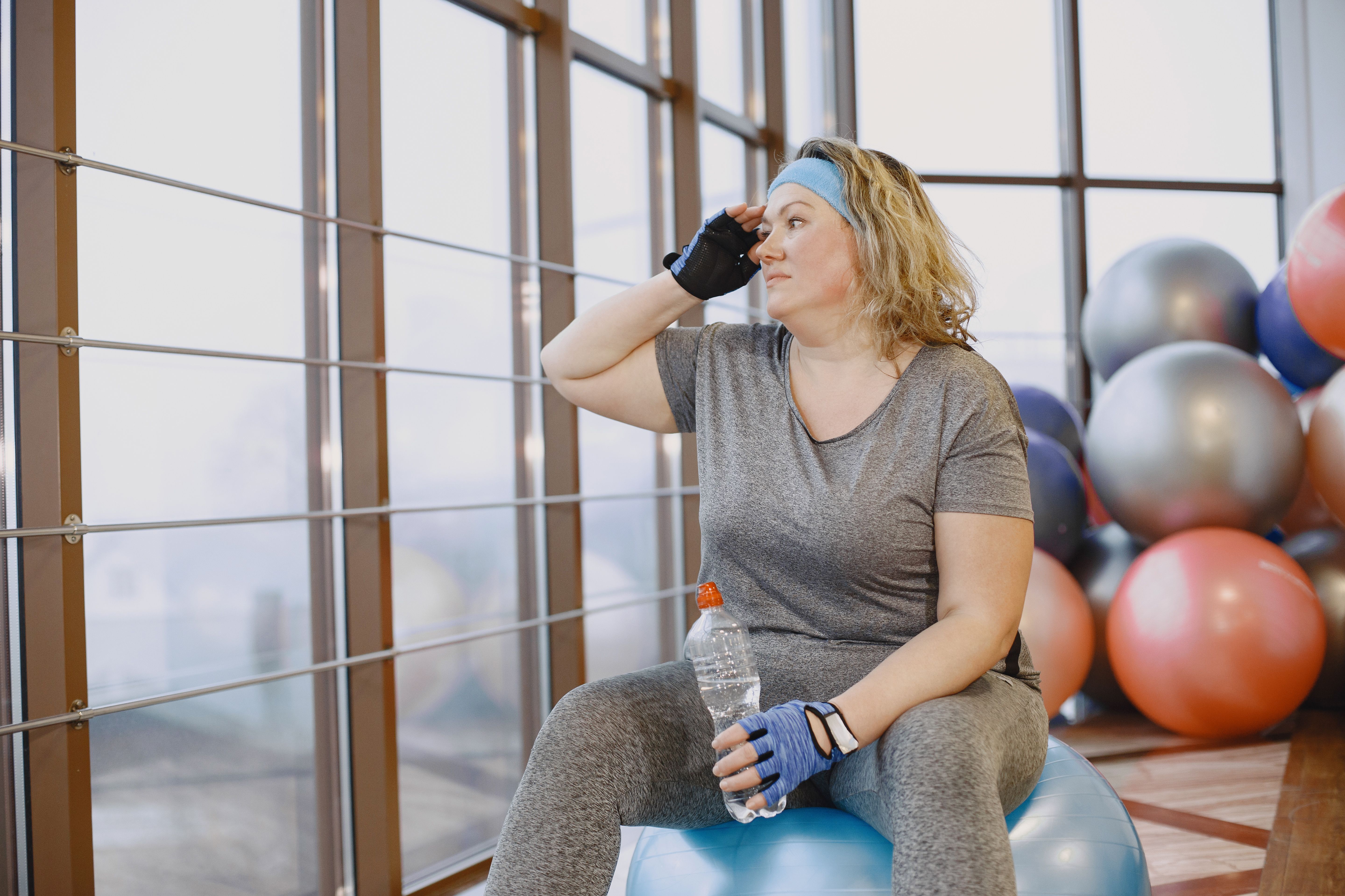 Adult fat woman have a rest at the gym