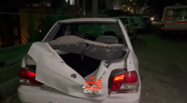 Damaged cars in Tehran's north Saturday, where state media reported a deadly strike.