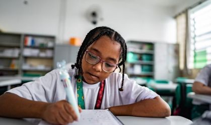 Schoolgirl studying in the classroom at school