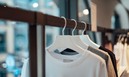 Clothes hanging on rack in fashion store