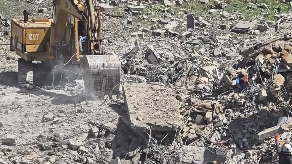 Rescuers clear rubble in Habboush, southern Lebanon, following Israeli strikes