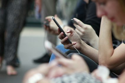 Jovem mexendo no celular