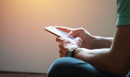 Hipster using a touch screen smart phone hands close up, vintage