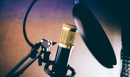 A sound recording studio microphone set up against brown background