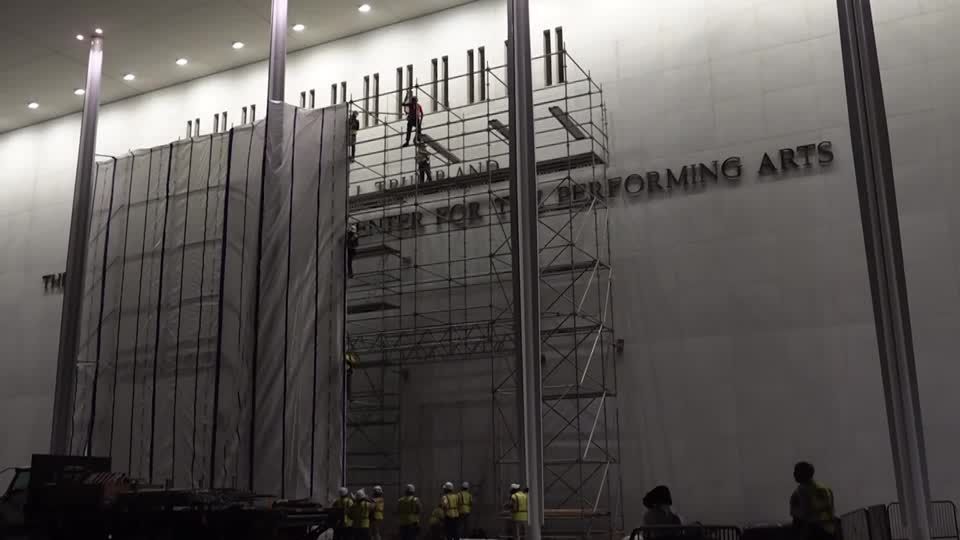 Workers remove Trump's name from Kennedy Center in Washington DC