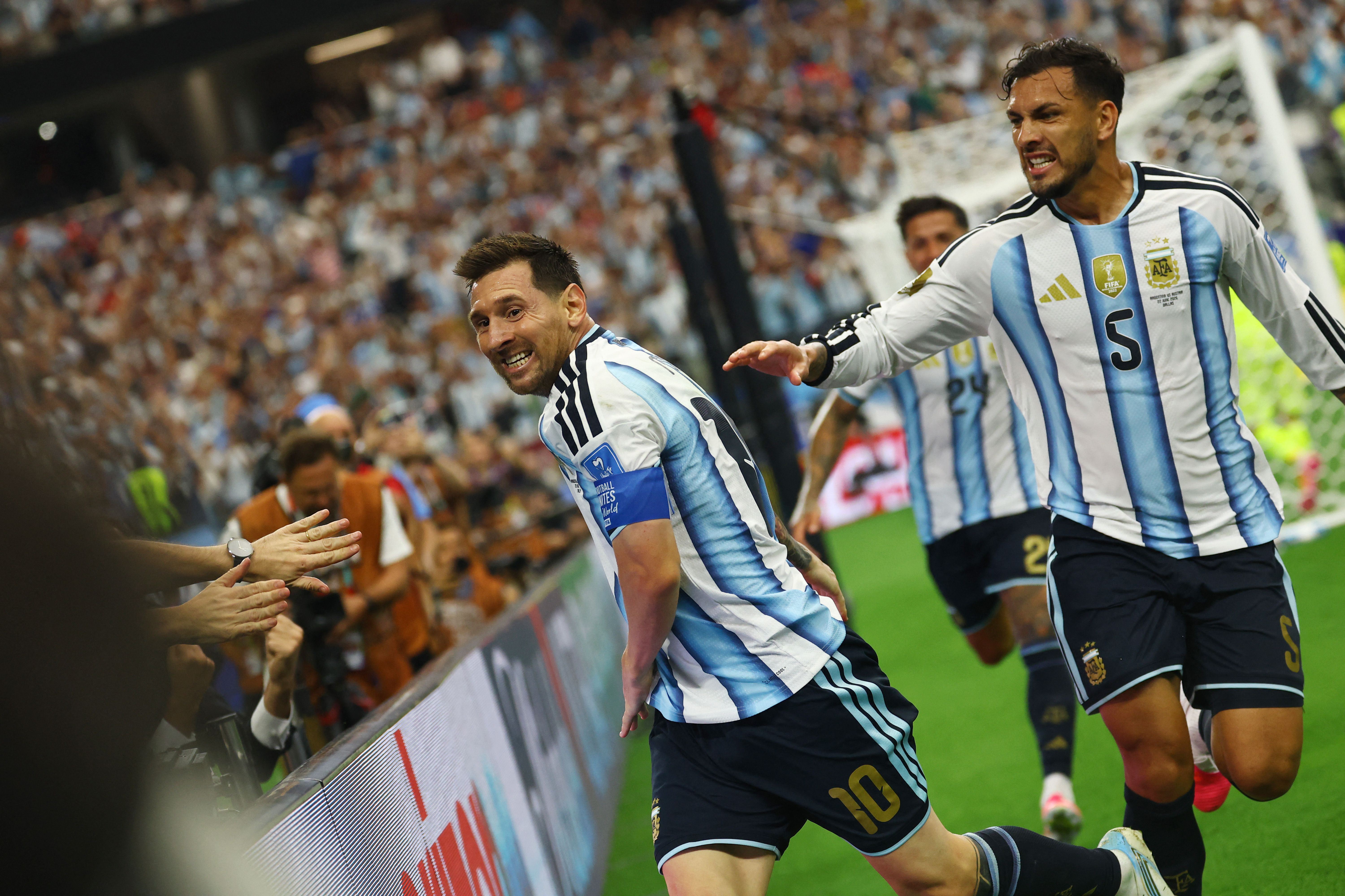 Lionel Messi, da Argentina, comemora o segundo gol com Leandro Paredes 22 de junho de 2026 REUTERS/Kai Pfaffenbach • REUTERS
