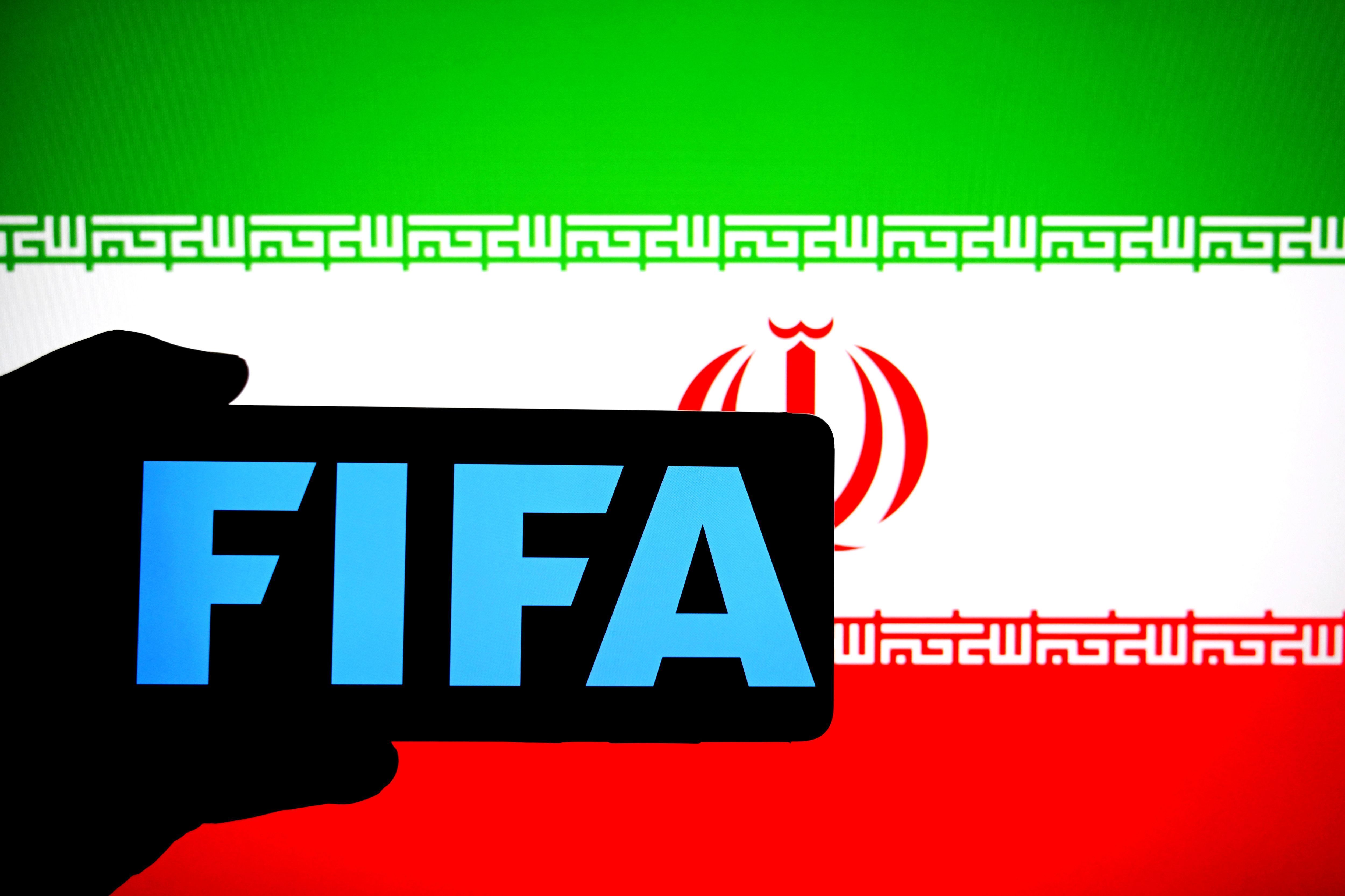 In this photo illustration, a FIFA logo is seen displayed on